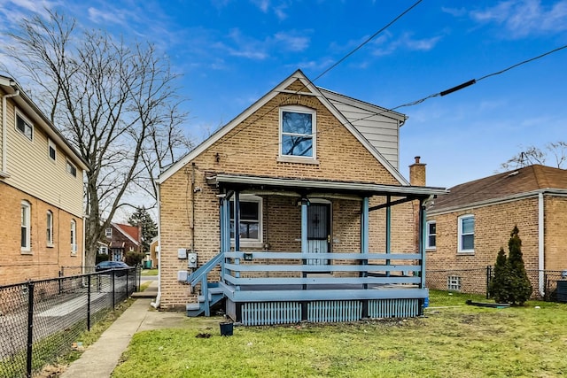 back of property featuring a porch and a lawn