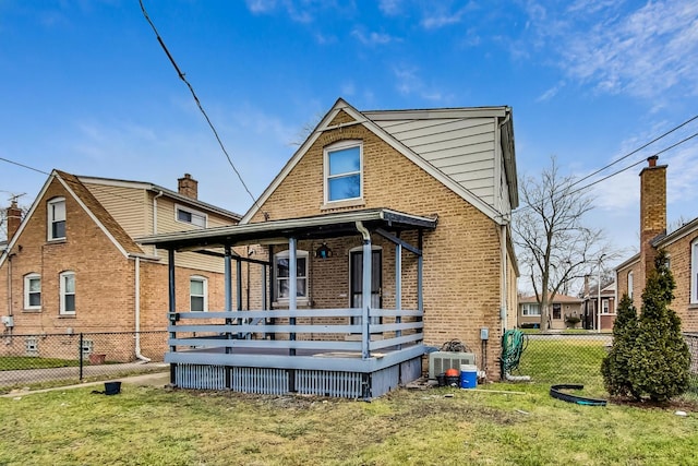 rear view of property featuring a wooden deck, a yard, and cooling unit