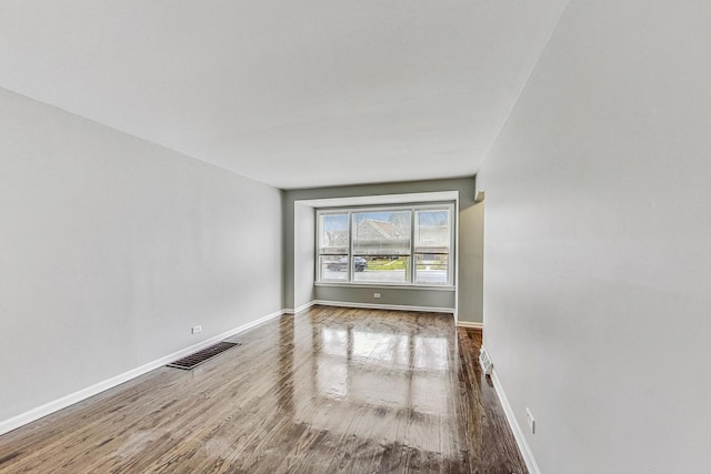 spare room with hardwood / wood-style flooring