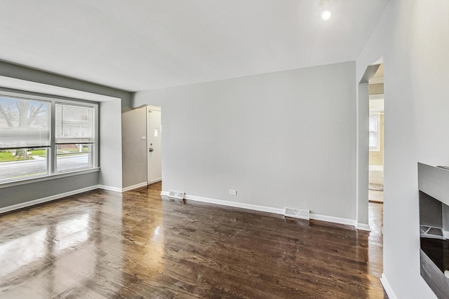 unfurnished living room with dark hardwood / wood-style floors