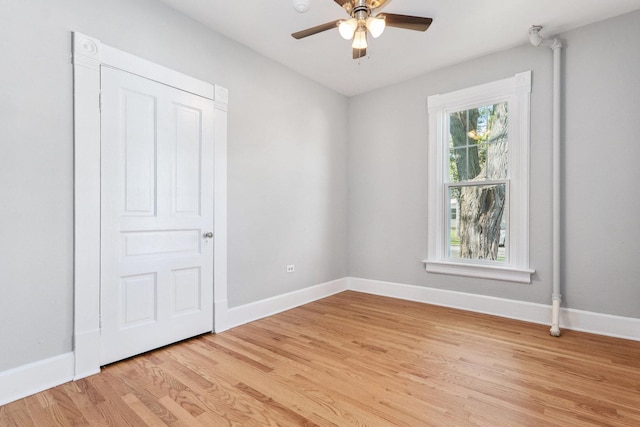 empty room with light hardwood / wood-style flooring and ceiling fan