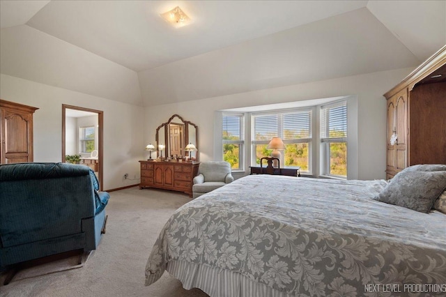 bedroom featuring light colored carpet, baseboards, and vaulted ceiling