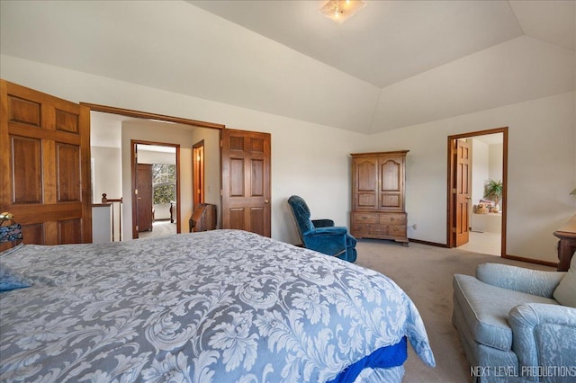 bedroom with light colored carpet, baseboards, and vaulted ceiling