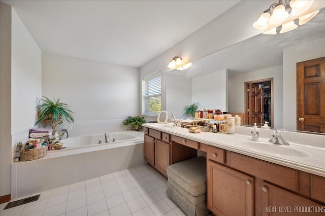 full bath featuring visible vents, double vanity, a sink, tile patterned flooring, and a garden tub