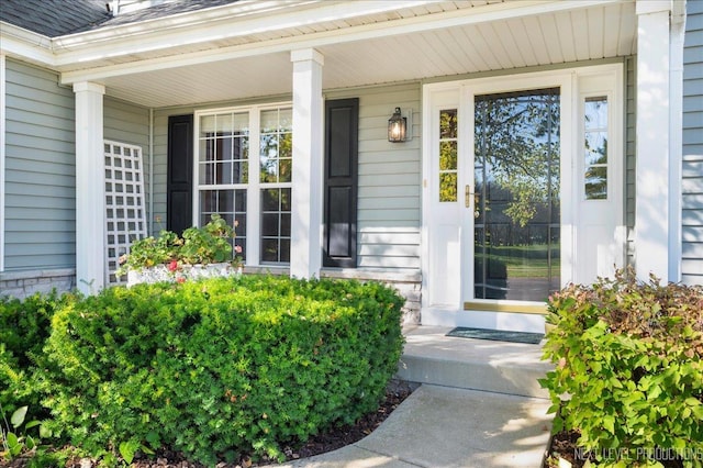 property entrance featuring a porch and roof with shingles