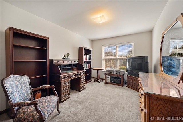 office space with baseboards and light carpet