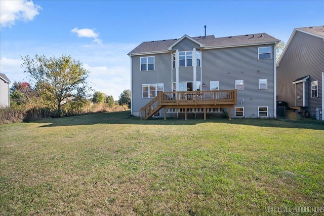 rear view of house with stairway, a yard, and a wooden deck