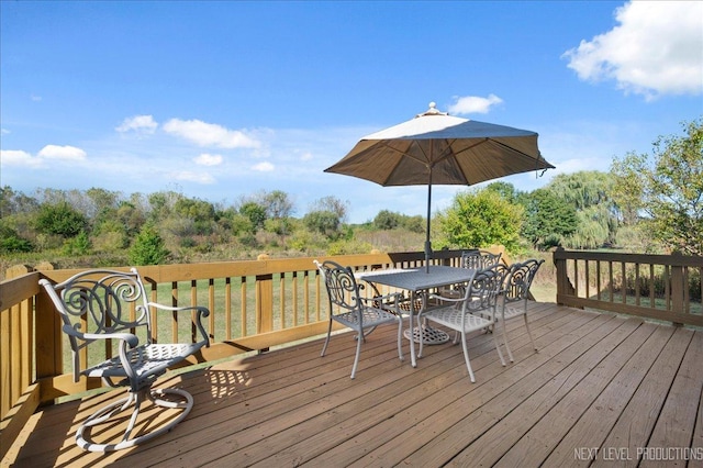 wooden terrace featuring outdoor dining space