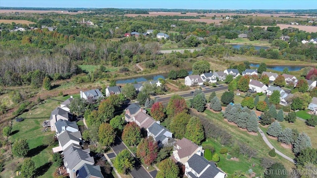 bird's eye view featuring a water view and a residential view