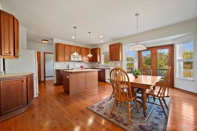 dining area featuring hardwood / wood-style flooring, recessed lighting, and baseboards