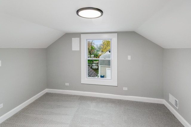 bonus room with carpet and vaulted ceiling