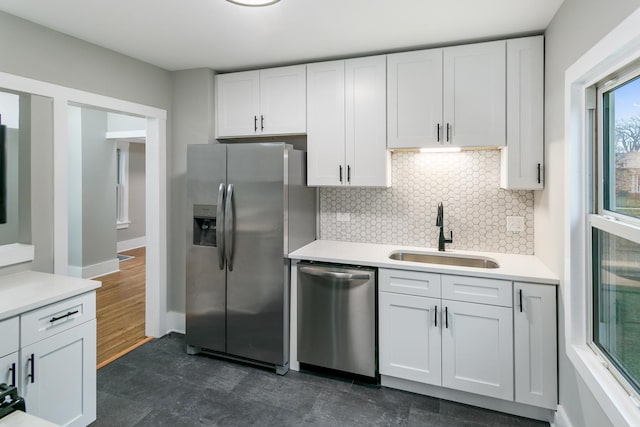 kitchen featuring white cabinets, stainless steel appliances, and sink