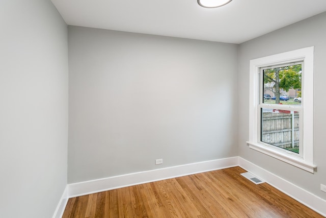 unfurnished room featuring hardwood / wood-style flooring