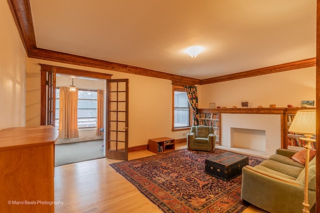 living room featuring french doors, wood-type flooring, and ornamental molding