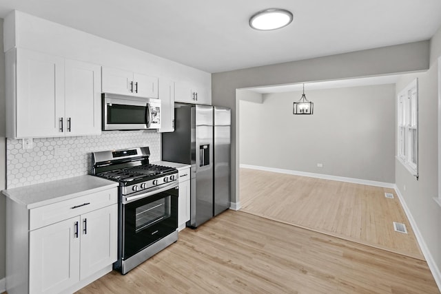 kitchen featuring light hardwood / wood-style flooring, white cabinets, and appliances with stainless steel finishes