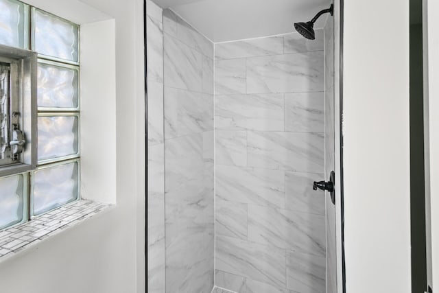 bathroom with tiled shower