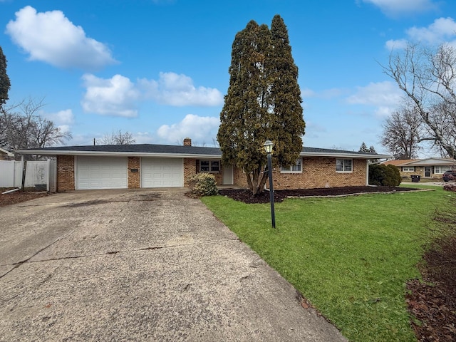 ranch-style home featuring a front lawn and a garage