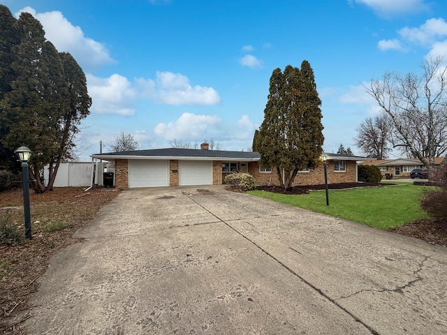 ranch-style home featuring a garage and a front lawn