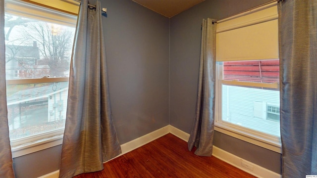 unfurnished room featuring dark hardwood / wood-style flooring