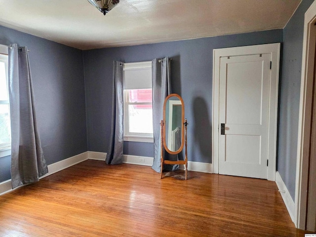 unfurnished room with light wood-type flooring