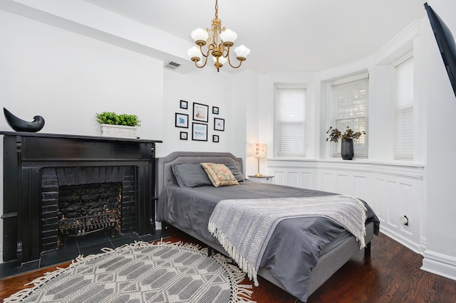 bedroom featuring dark wood-type flooring and an inviting chandelier