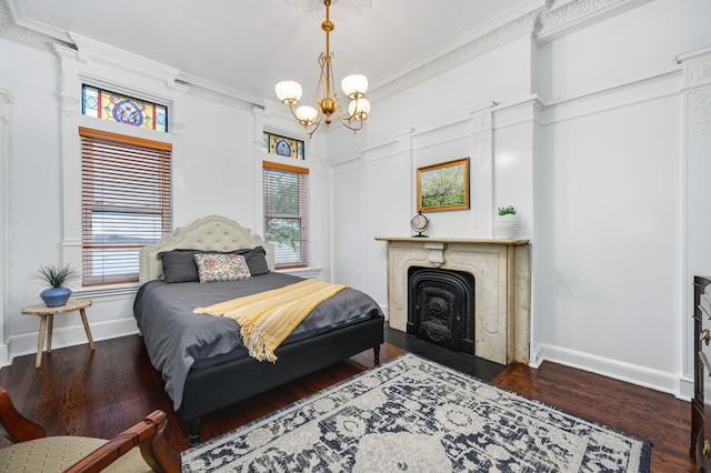 bedroom with dark hardwood / wood-style floors, crown molding, and a chandelier