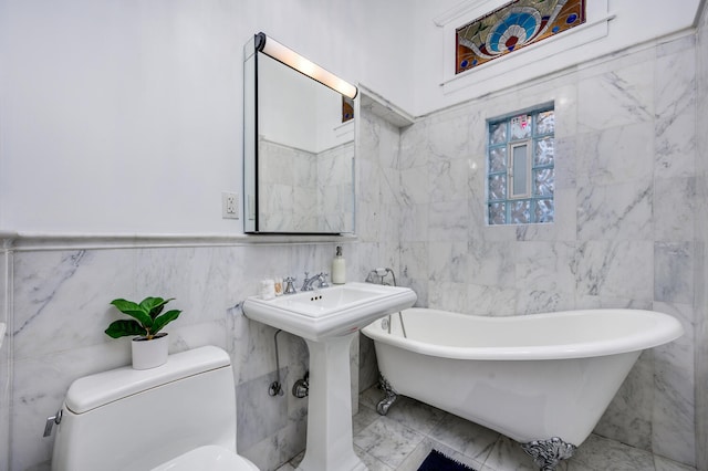 bathroom with toilet, tile walls, and a tub