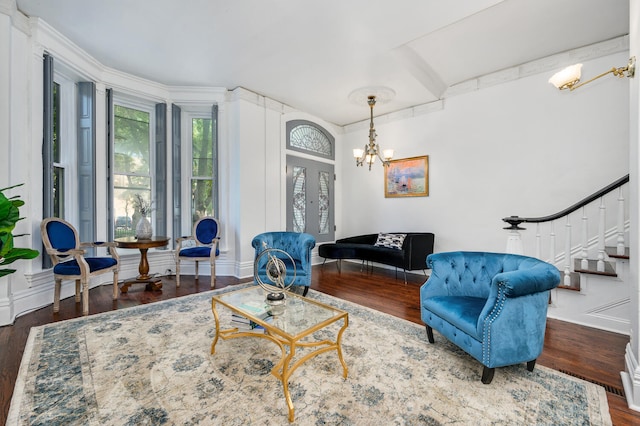 living room with french doors, dark hardwood / wood-style flooring, and an inviting chandelier