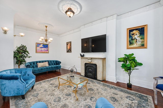 living room featuring a chandelier and dark wood-type flooring