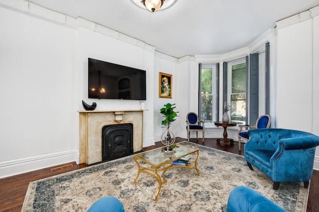 living room featuring a high end fireplace and dark hardwood / wood-style floors