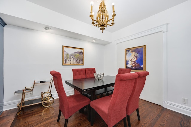 dining room featuring dark wood-type flooring and an inviting chandelier