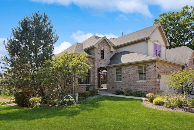 view of front of house featuring a garage and a front yard