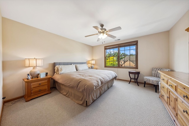 bedroom featuring light carpet and ceiling fan