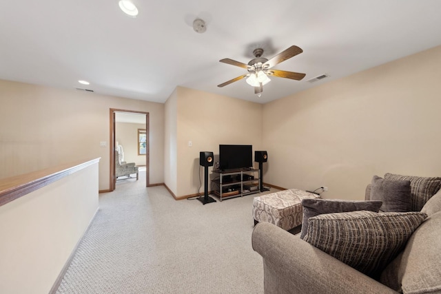 carpeted living room with ceiling fan