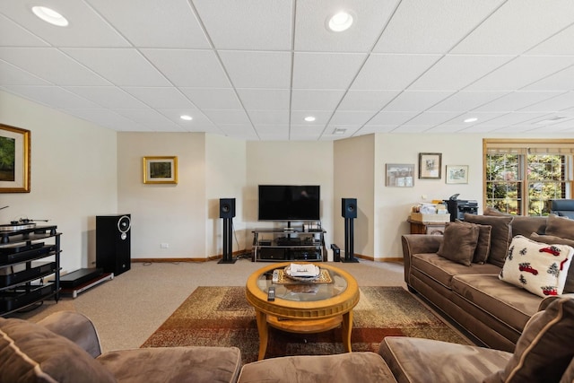 carpeted living room with a drop ceiling