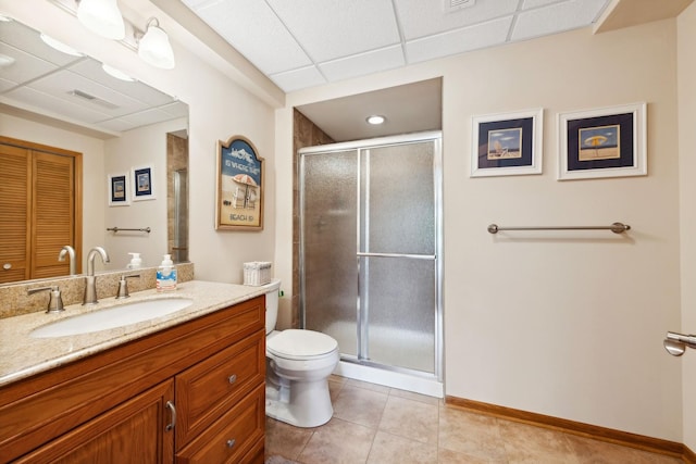 bathroom featuring tile patterned flooring, vanity, walk in shower, and toilet