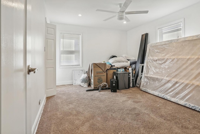 interior space featuring carpet flooring, ceiling fan, and a wealth of natural light