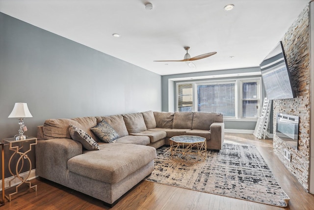 living room featuring hardwood / wood-style flooring and ceiling fan