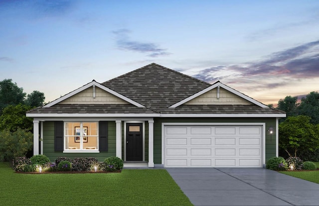 view of front of house with a garage and a lawn