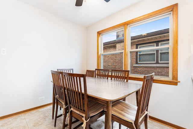 dining space featuring ceiling fan and light tile patterned flooring