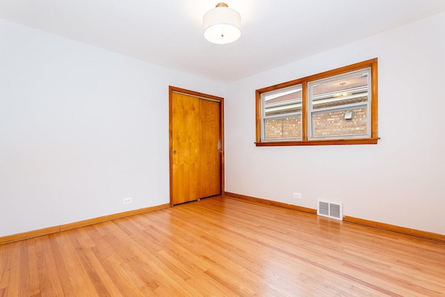 spare room with light hardwood / wood-style flooring