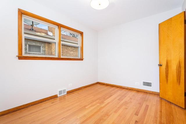 unfurnished room with light hardwood / wood-style floors