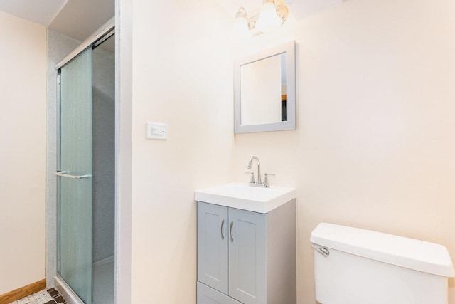 bathroom featuring an inviting chandelier, vanity, an enclosed shower, and toilet