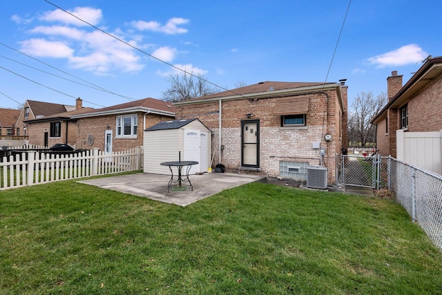 back of house featuring a yard, a patio, and central air condition unit