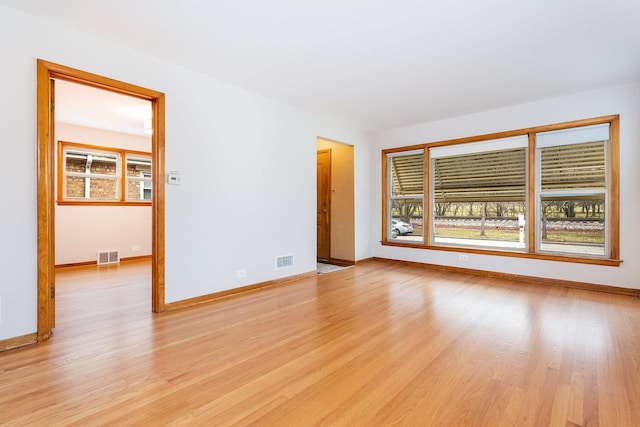 unfurnished room with light wood-type flooring