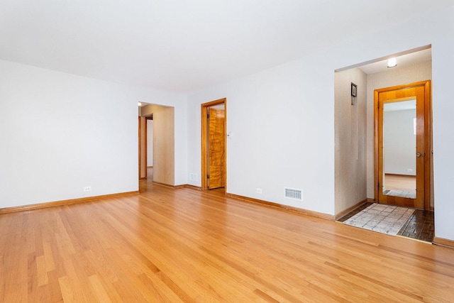 spare room featuring light hardwood / wood-style flooring