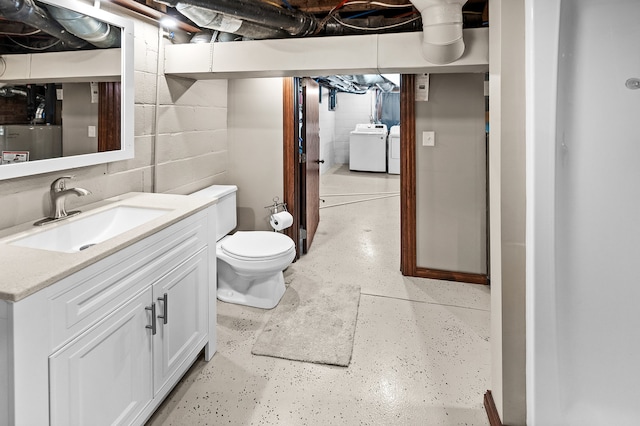 bathroom with vanity, toilet, and washer and clothes dryer