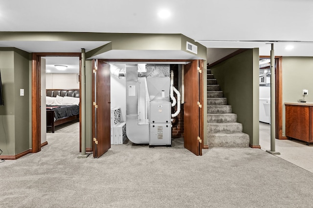 basement with heating unit and light colored carpet