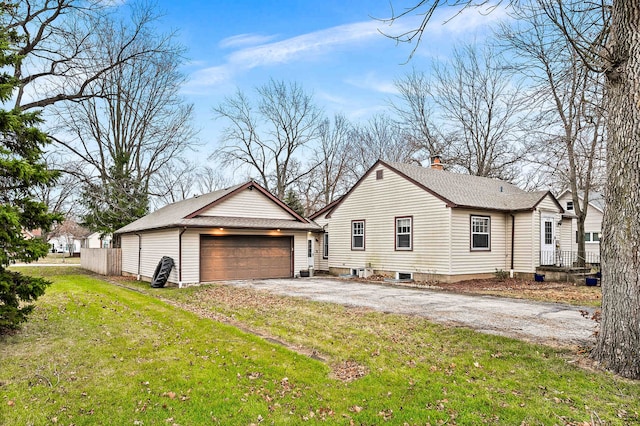 view of property exterior featuring a garage and a lawn