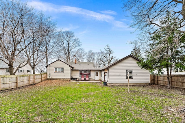 rear view of property featuring a lawn and a patio area